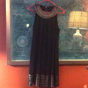Black halter dress with silver stitching detail.